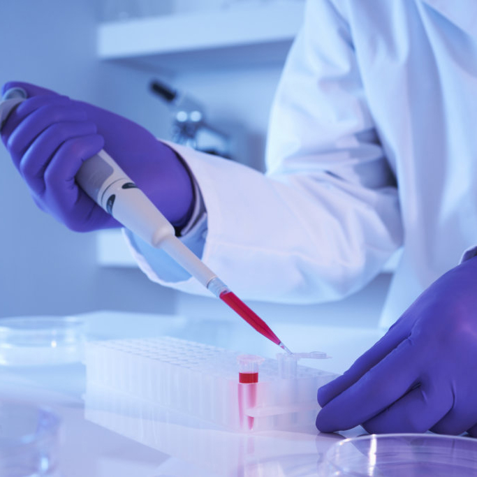 Scientist using pipette in laboratory