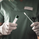 nurse holds a swab for covid19 test