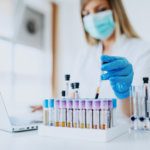 lab assistant holding test tube with blood sample