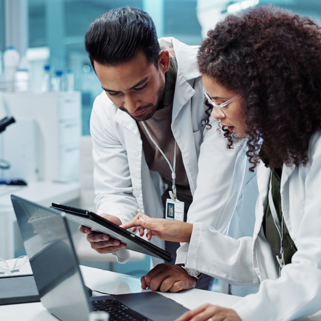 two scientists working with a tablet